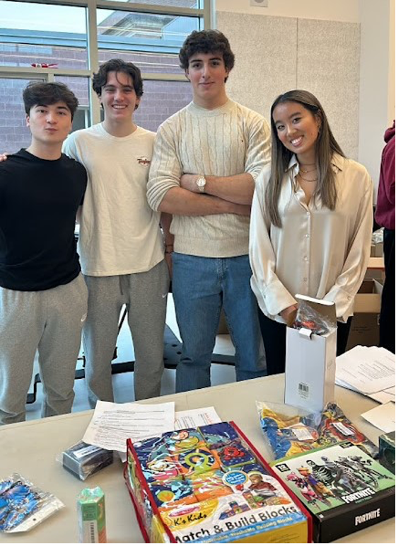 Two volunteers join Lucas and Olivia Zhang at the CKF gift event at AHS.