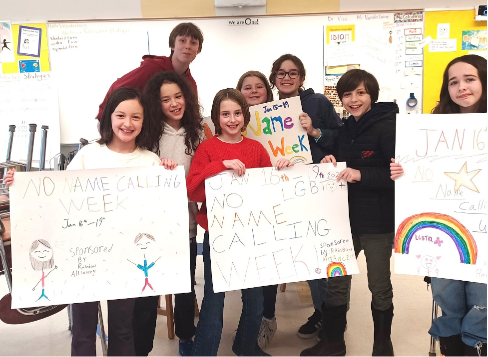 Brackett Rainbow Alliance members and posters they made for No Name Calling Week.